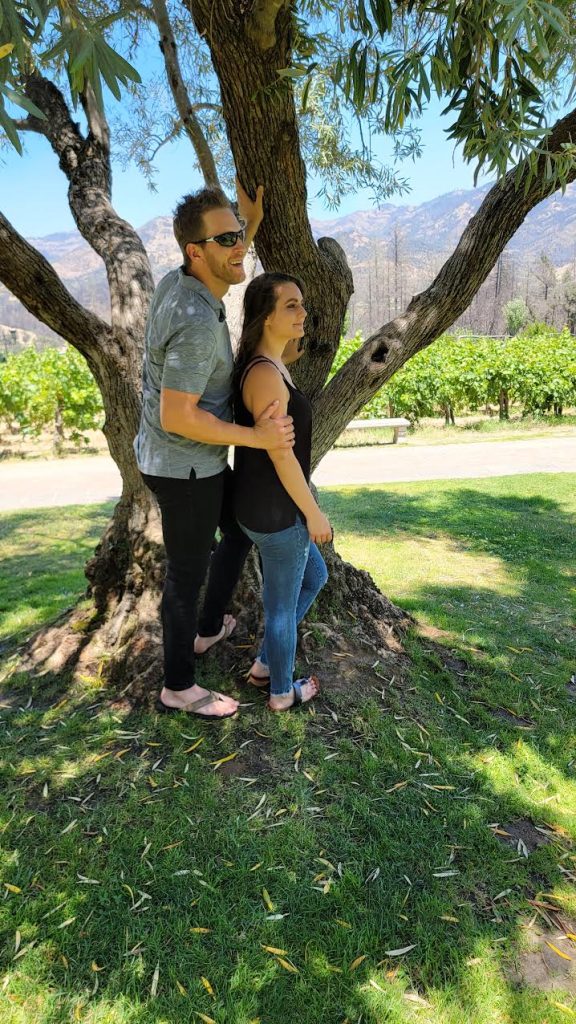 Ashley Young and Justin Young in Napa Valley in the shade of a tree